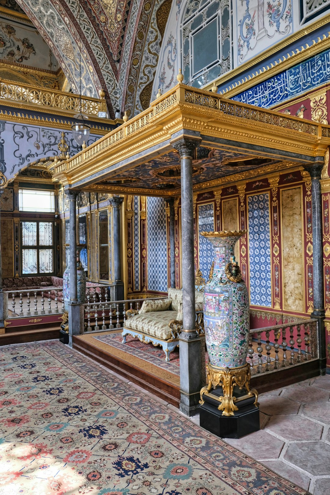 a bed in a room with a rug on the floor