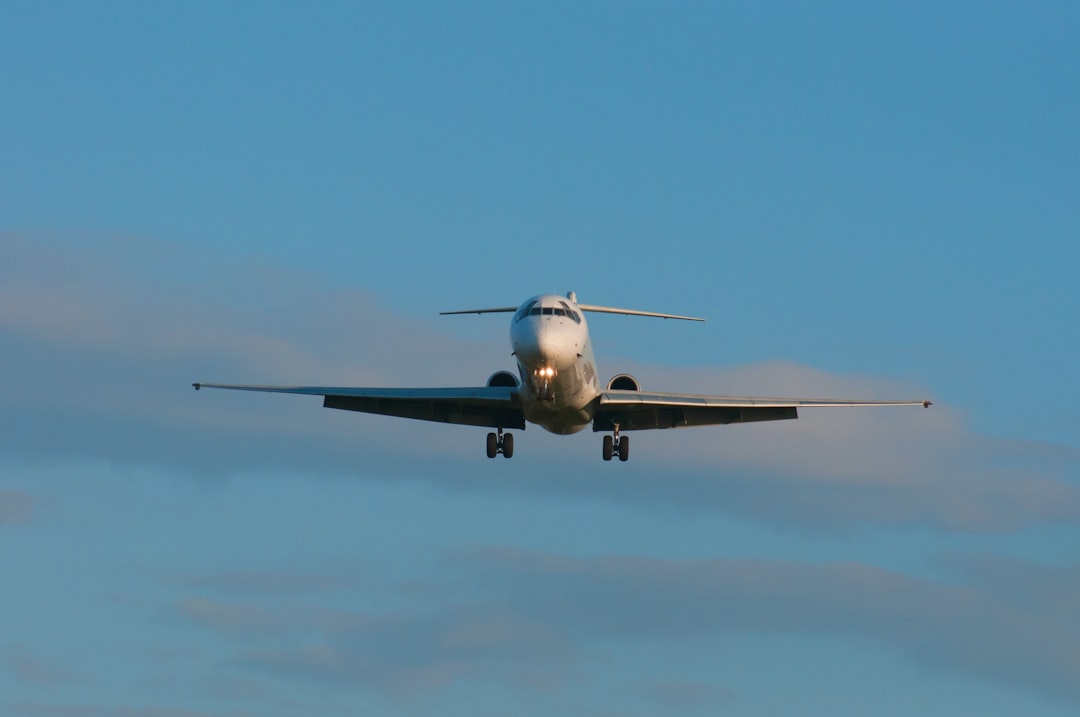 a large jetliner flying through a blue sky
