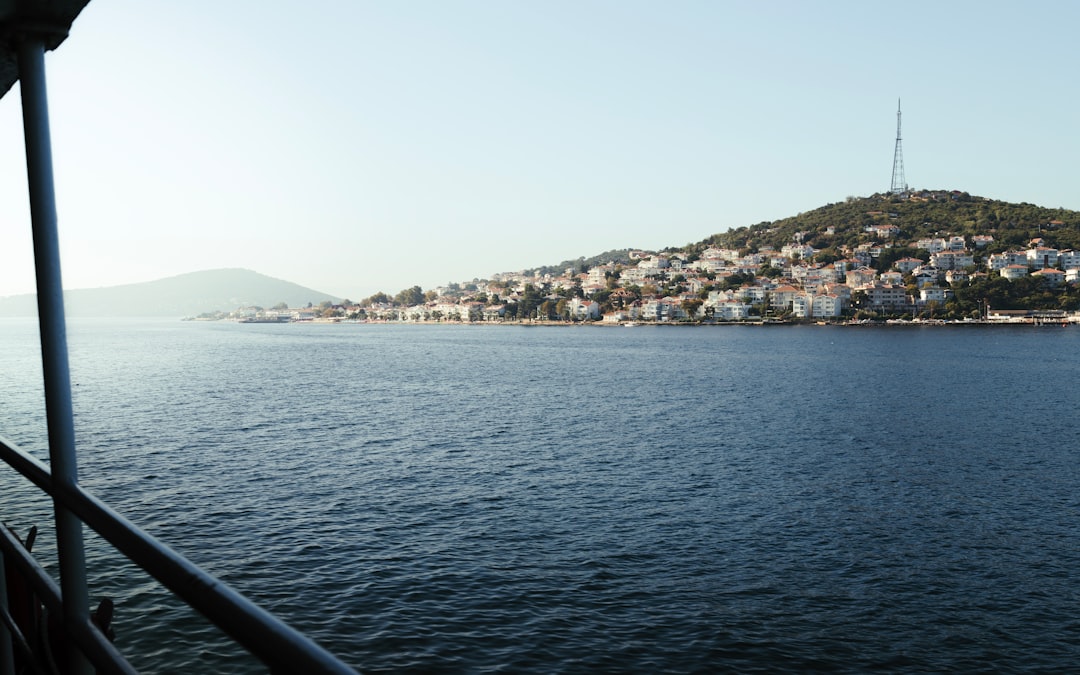 a body of water with a hill in the background